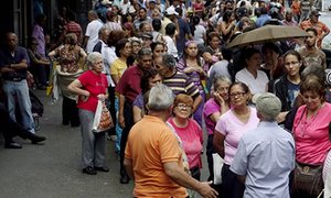 People queueing to buy food are prey for thieves in Caracas, capital of Venezuela. Photograph: Carlos Garcia Rawlins/Reuters 
