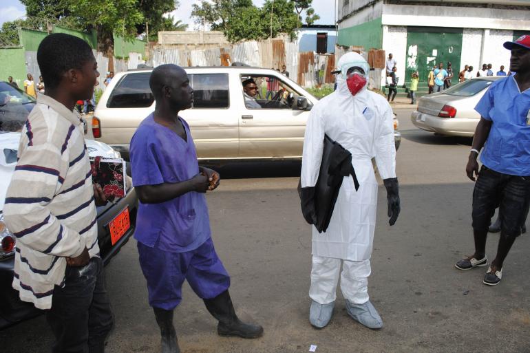 A health worker prepares to remove a dead body infected with the Ebola virus in Monrovia, Liberia, Sept. 11. Reuters/James Giahuye