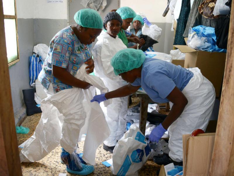   Medical workers in Monrovia, Liberia, put on their protective suits before treating Ebola patients Dominique Faget/AFP/Getty Images