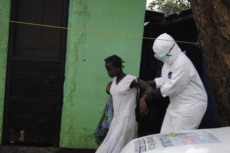 A health worker brings a woman suspected of having contracted the Ebola virus to an ambulance in Monrovia, Liberia, September 15, 2014. Airlines have halted many flights into and around West Africa, where governments have closed some borders and imposed travel restrictions in a bid to fight an Ebola outbreak that has killed over 2,400 people. (Stringer/Reuters)